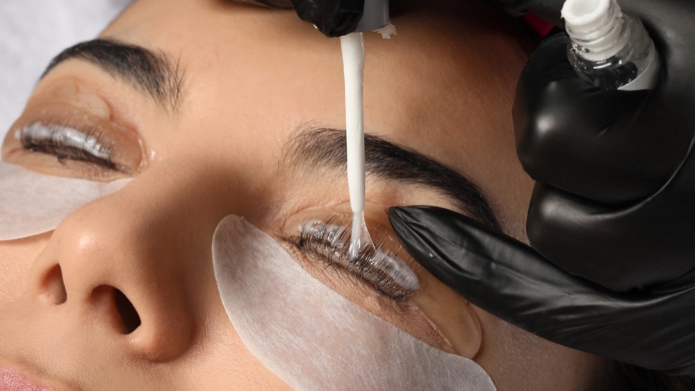 Eyelash Extension Procedure. Woman Eye with Long Eyelashes